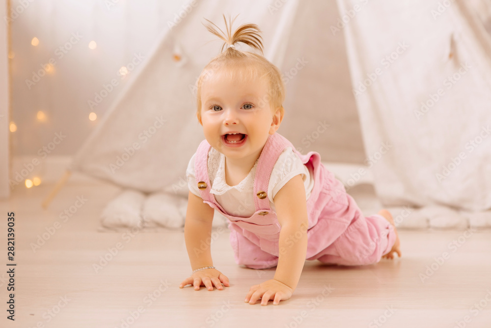 baby girl playing in the nursery, baby learning to walk, textiles for the nursery., tent in the children's room baby girl playing in the nursery, baby learning to walk, textiles for the nursery., tent in the children's room