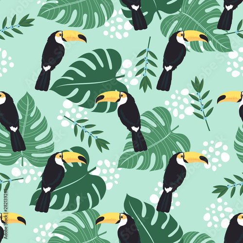 seamless pattern with toucan and leaves on blue background