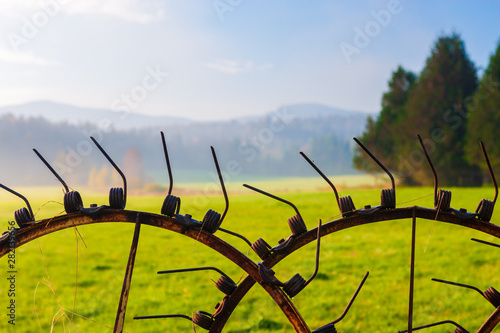 Fototapeta Naklejka Na Ścianę i Meble -  Antique farm machinery on a foggy autumn morning.