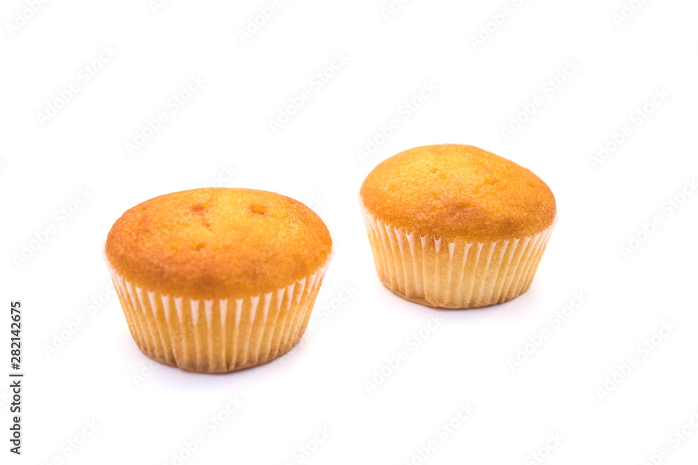 two Christmas cupcakes in pink, decorated with yellow and pink stars and a candy stick on the top, on a white background. two Christmas cupcakes in pink, decorated with yellow and pink stars and a candy stick on the top, on a white background.
