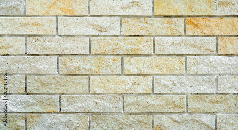Naklejka premium Yellow brick background. Yellow brick wall. Textured background for your design