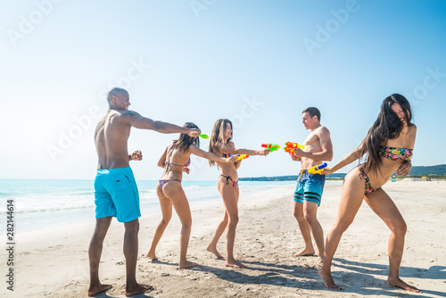 Friends having fun on the beach © oneinchpunch
