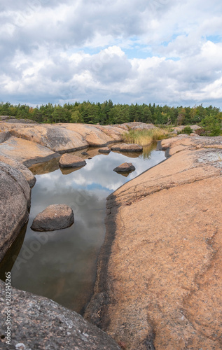 Rocky island in the Baltic Sea, Finland. Landscape with huge stones and cracks in the granite massif. The environmentally friendly nature of Northern Europa Scandinavia.