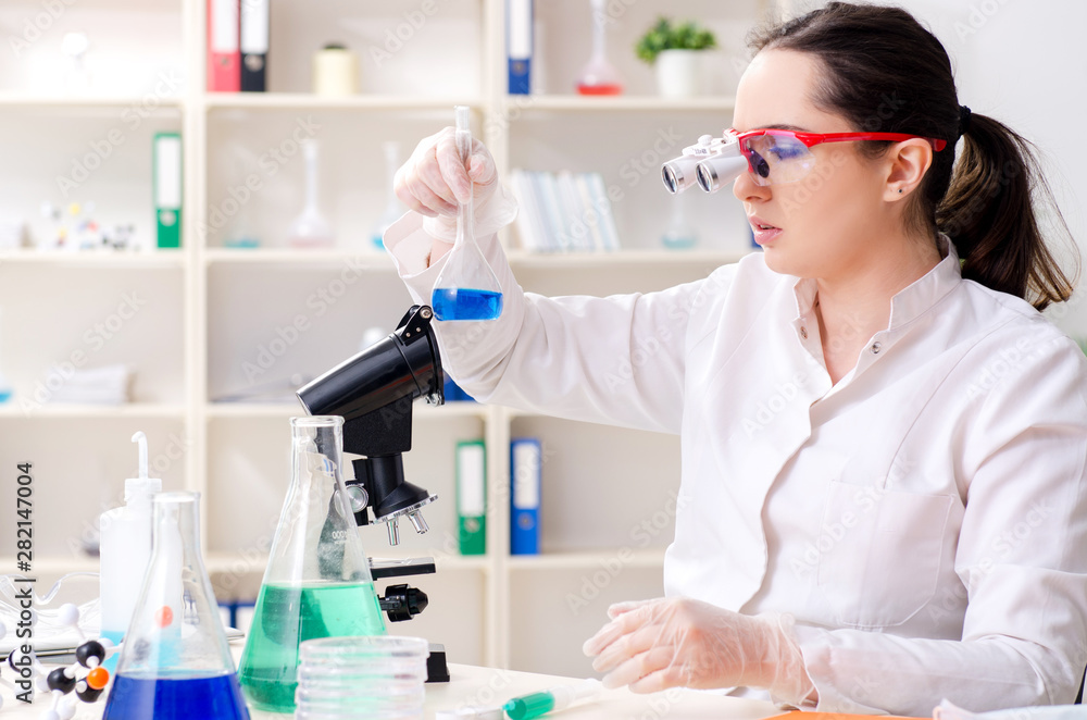 Young female chemist working in the lab Young female chemist working in the lab