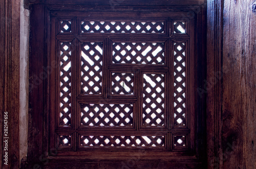 Medersa Ben Youssef - Marrakech, Morocco. Mashrabiya, type of window salient oriel closed by a trellis carved wood. photo