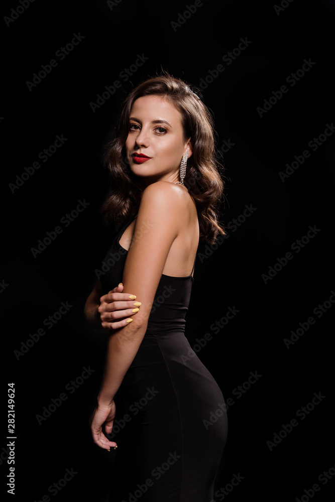 young woman in dress standing isolated on black young woman in dress standing isolated on black