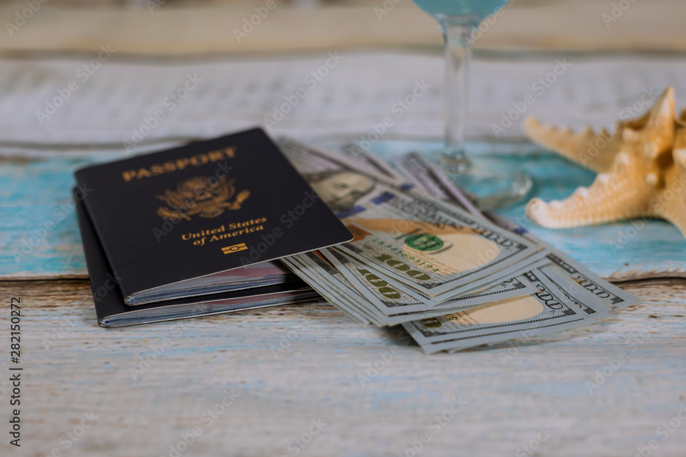 Φωτογραφία US passport with cash money and starfish, travel concept.