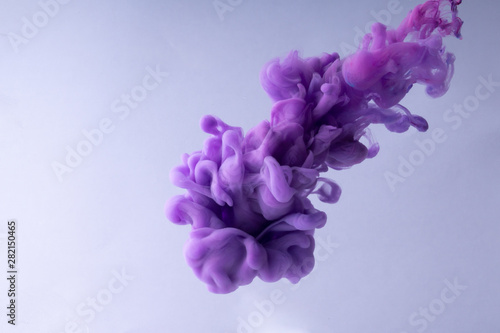 Colorful Ink swirling in water. Cloud of silky ink on white background.
