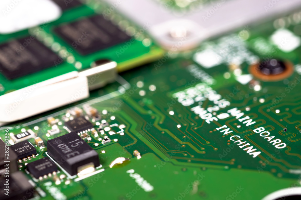 Trade war , Made in CHINA and industry technology concept. Selective focus on text screen on the production of printed circuit boards (PCB). Factory move out of China. Trade war , Made in CHINA and industry technology concept. Selective focus on text screen on the production of printed circuit boards (PCB). Factory move out of China.