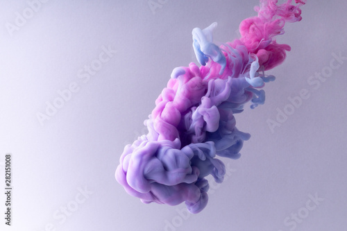 Colorful Ink swirling in water. Cloud of silky ink on white background.