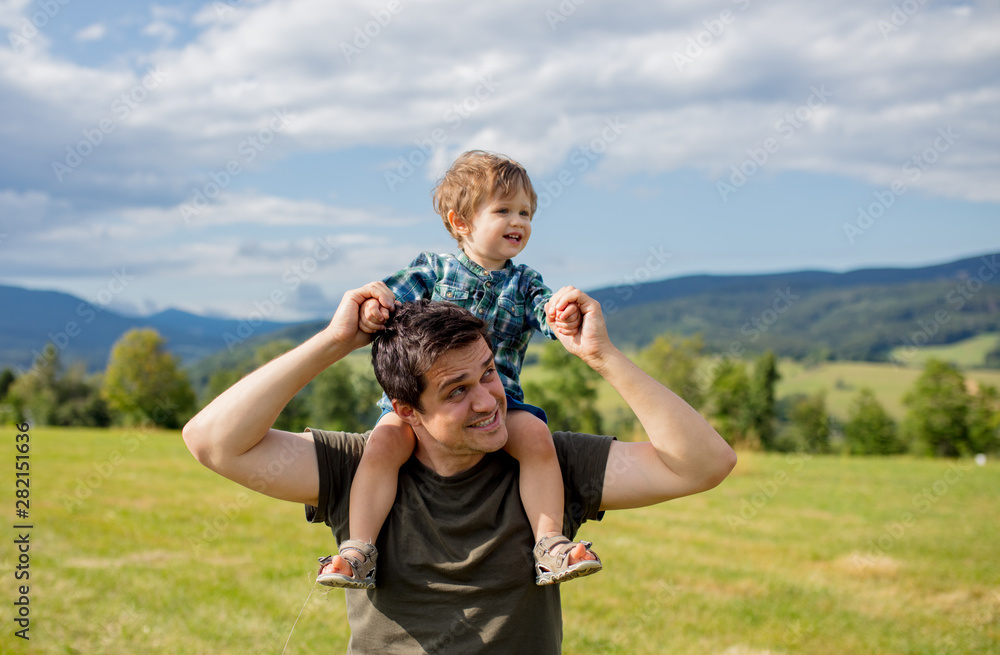 Father and toddler boy have a fun in a mountains Father and toddler boy have a fun in a mountains