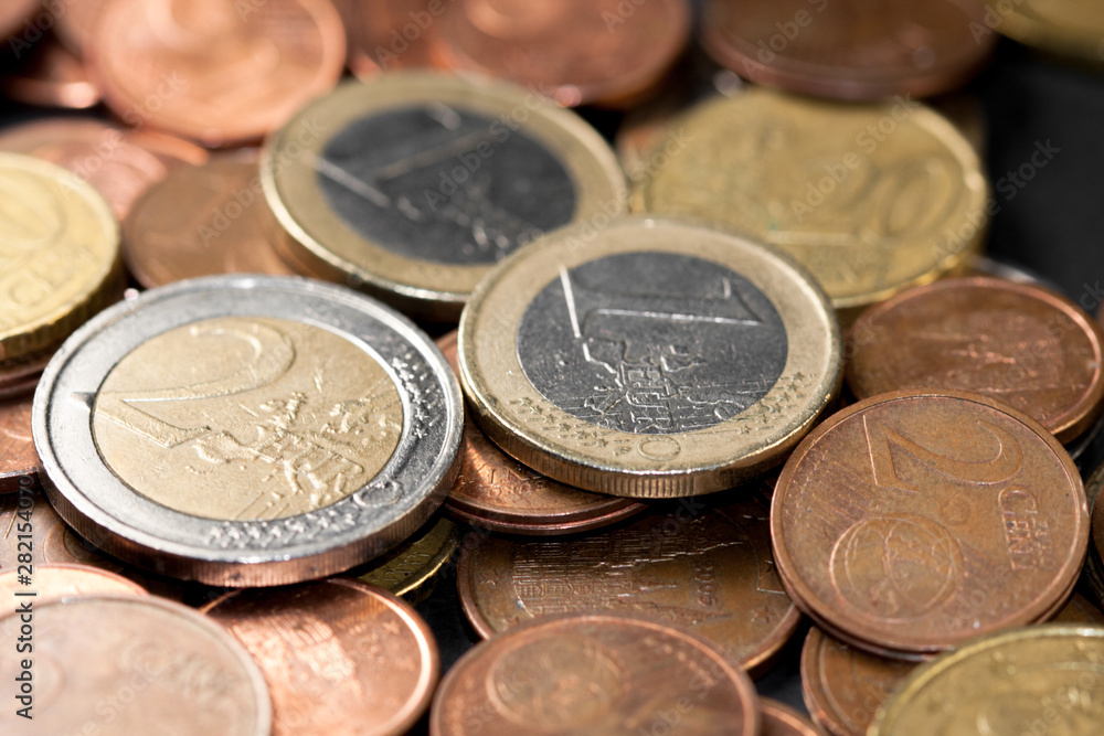 Different amounts of scattered European coins on a black background. Different amounts of scattered European coins on a black background.