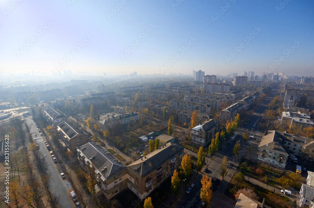 The aerial View of residential district in sunny summer morning.View over the city rooftops with sunlight and trees.Moderns buildings at Industrial uptown, residential neighbourhood.