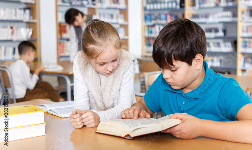 Girl and boy studying in school library