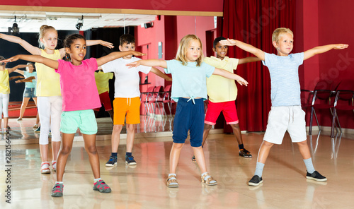 Boys and girls having dancing class in studio
