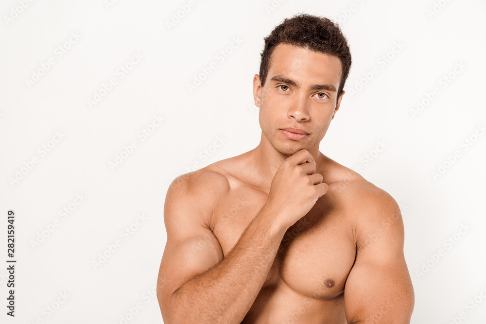 pensive mixed race man touching chin while standing on white pensive mixed race man touching chin while standing on white