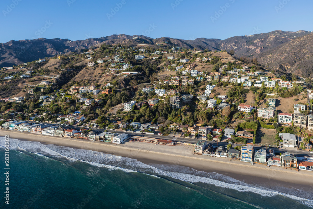 Aerial of shoreline homes and buildings north of Los Angeles on scenic Pacific Coast Highway in Malibu, California.  