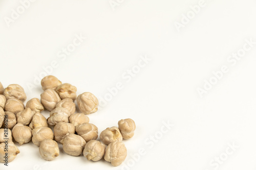 Dry raw organic chickpeas isolated on white background.