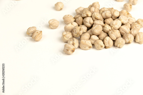Dry raw organic chickpeas isolated on white background.