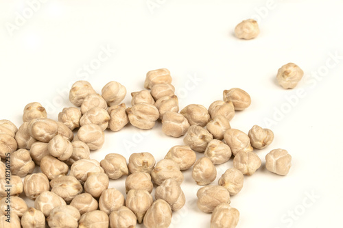 Dry raw organic chickpeas isolated on white background.
