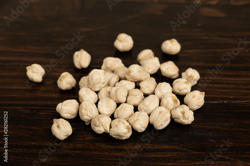 Raw chickpeas  on a dark wooden background. top view, out of range.