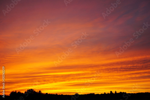 Bright orange sunset, yellow clouds © Nina