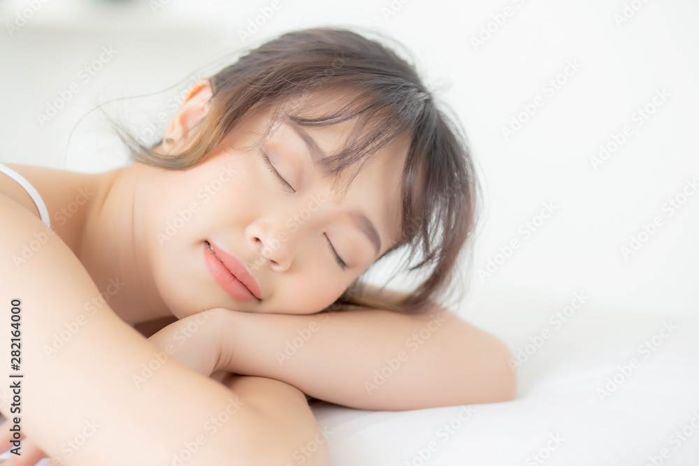 Beautiful asian young woman smile sleeping lying on bed with comfortable and happy leisure at bedroom, beauty asia girl wellness with relax and fresh for health concept. Beautiful asian young woman smile sleeping lying on bed with comfortable and happy leisure at bedroom, beauty asia girl wellness with relax and fresh for health concept.