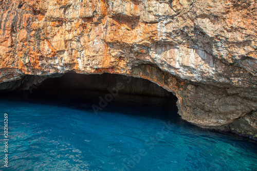 coastal cavern with blue sea water 