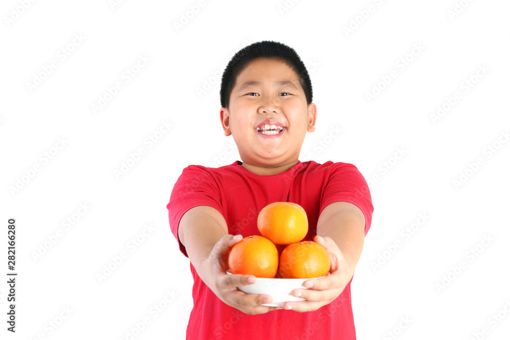 Chinese children wearing red shirts holding orange with pleasure.isolated Chinese children wearing red shirts holding orange with pleasure.isolated