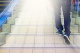 Pathway to success concept a man walk on the stair with space area for write some text on a blue background meaning walk to success concept