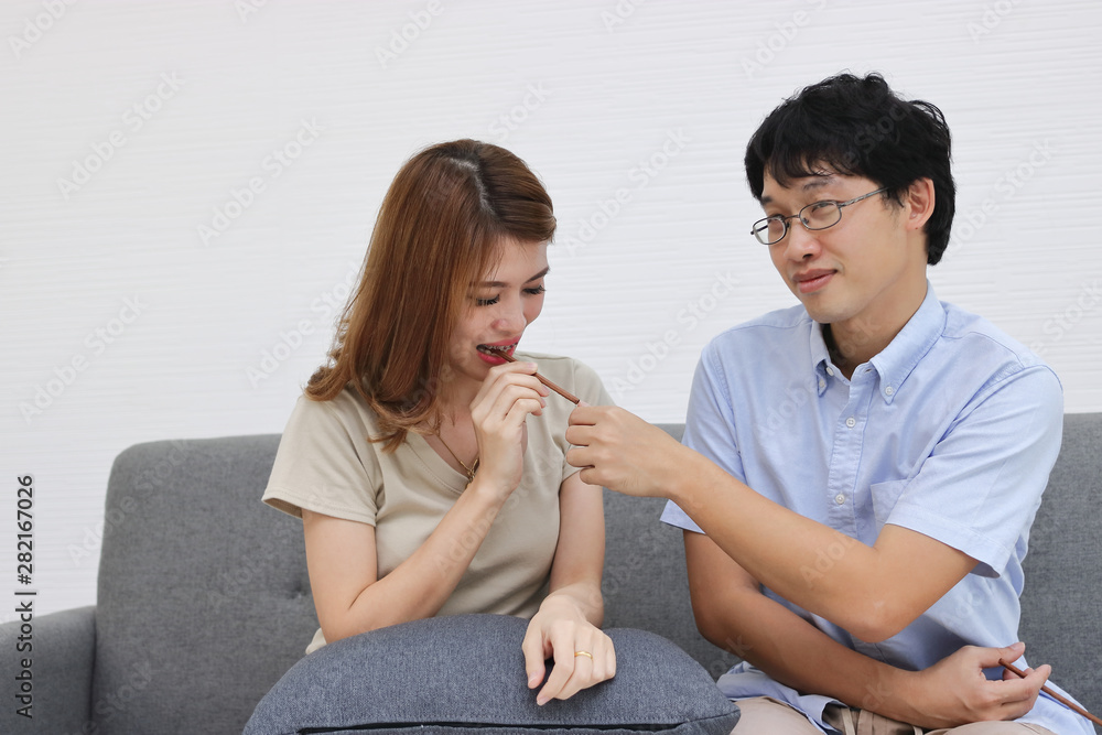 Sweet and romance young Asian couple in love and have happiness in living room. Sweet and romance young Asian couple in love and have happiness in living room.