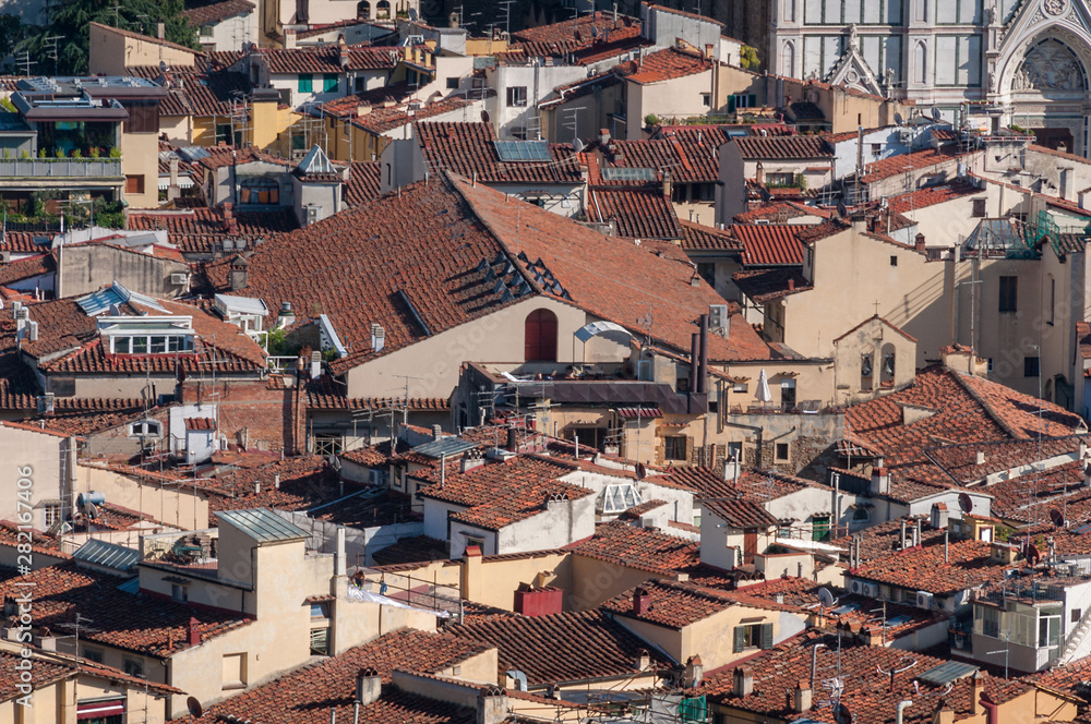 Birds eye view of red-tiled rooftops of Florence historic cenrte in Italy