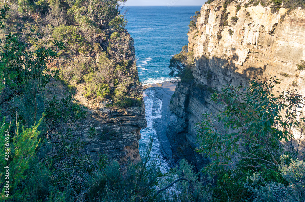 Narrow cliff gulch, gorge and open ocean view
