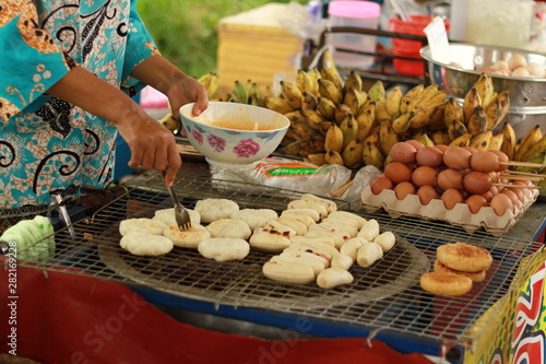 Sticky rice toast and Grilled banana on a charcoal stove, Thailand local street food