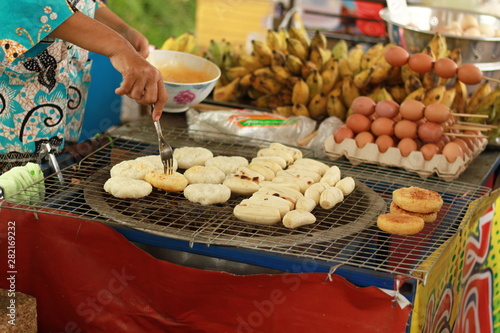 Sticky rice toast and Grilled banana on a charcoal stove, Thailand local street food
