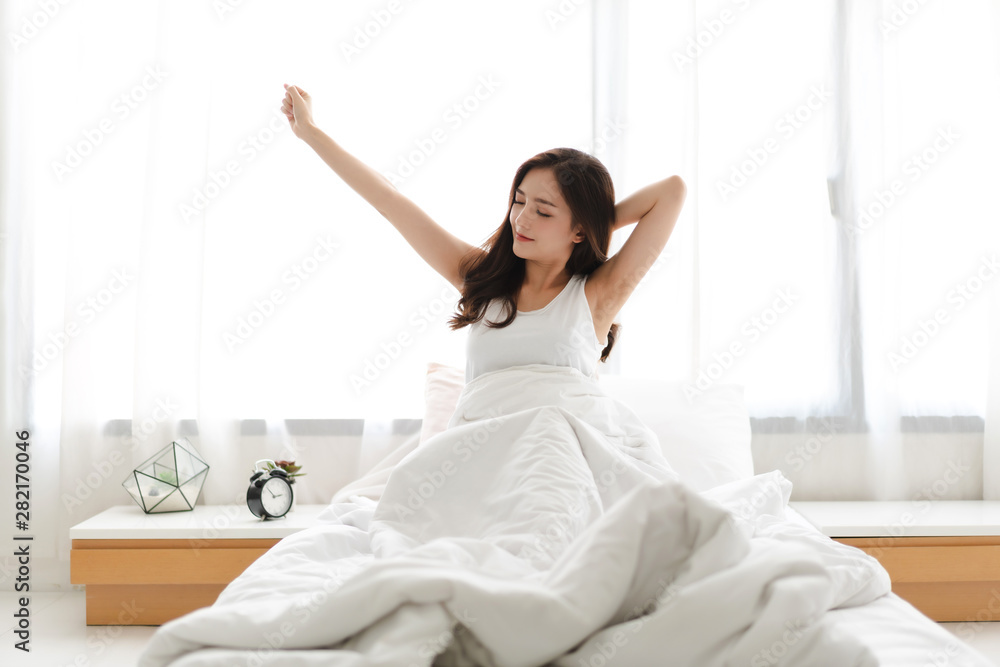 Woman stretching happy and relaxed after wake up in the morning at home Woman stretching happy and relaxed after wake up in the morning at home