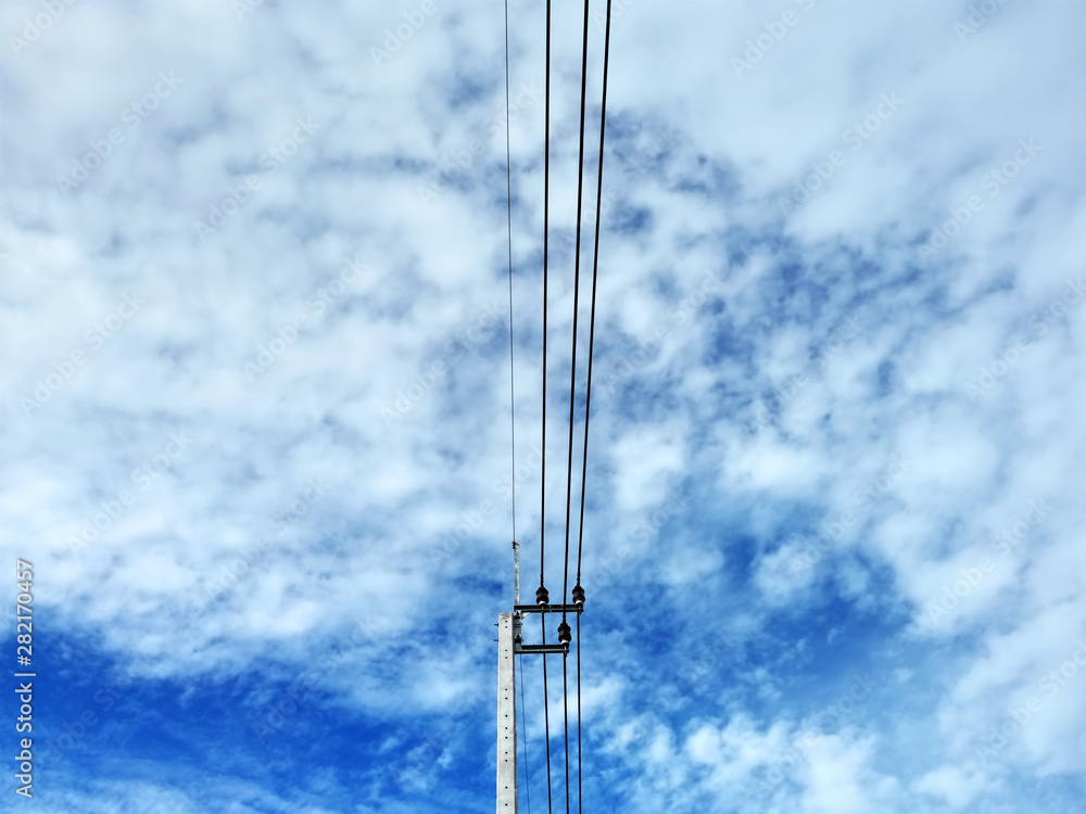 Low Angle View of Electrical Pole and Cables Against Blue Cloudy Stormy Sky Low Angle View of Electrical Pole and Cables Against Blue Cloudy Stormy Sky