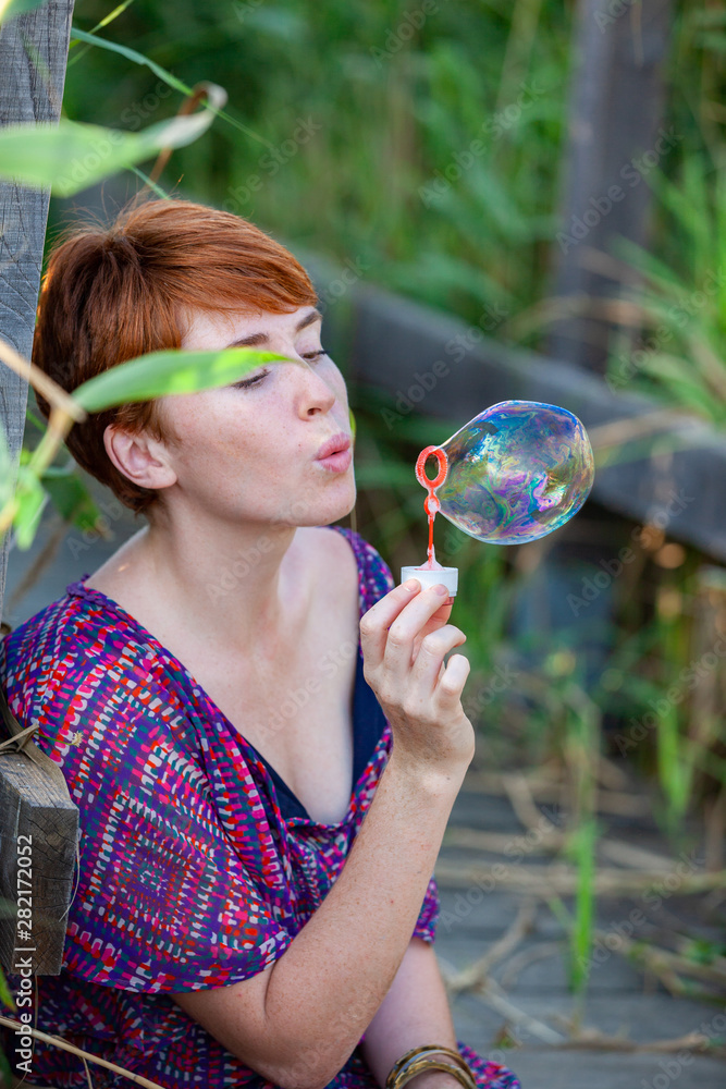 WOMAN SITTING ON A GANGWAY WITH BUBBLES. WOMAN SITTING ON A GANGWAY WITH BUBBLES.