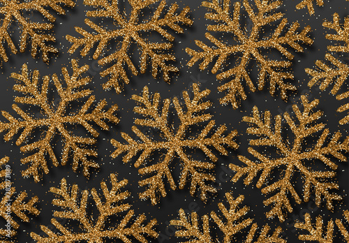 Background golden snowflakes strewn with bright sparkles