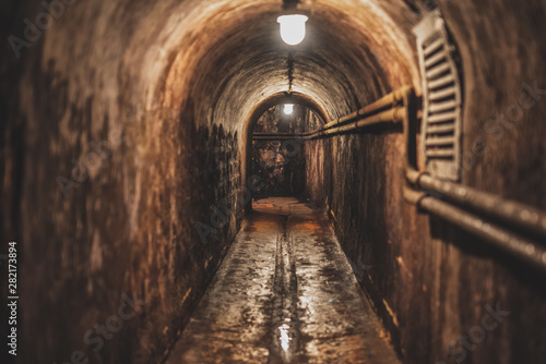 long dark narrow underground tunnel with lighting © vadimalekcandr