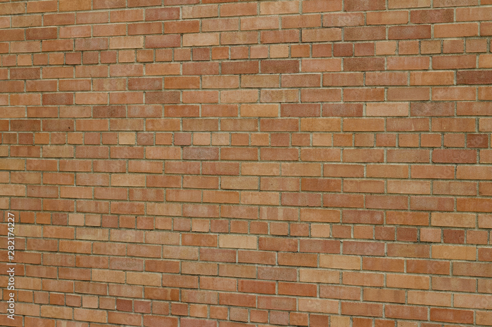 Fototapeta premium Attractive but grungy rose beige color brick wall texture background (angle view)
