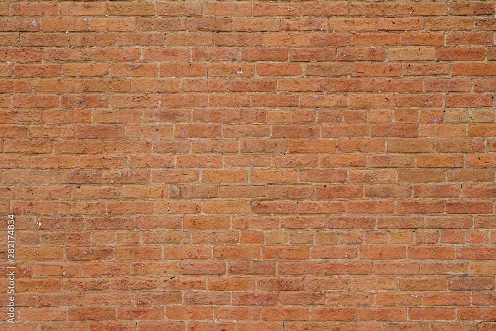 Obraz Old reddish orange brick wall background with cracks and worn texture