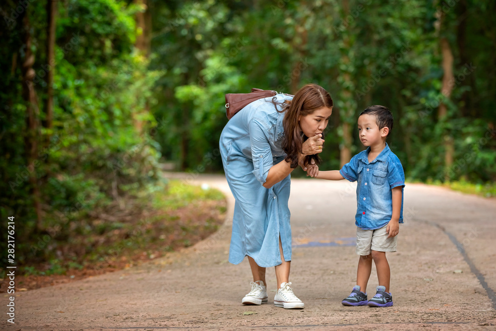 Happy mother and adorable little boy enjoying warm weather at beautiful park Happy mother and adorable little boy enjoying warm weather at beautiful park