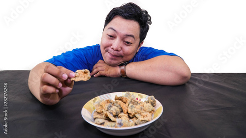 fat or overweight Asian man sad lookin at fish chips isolated in white,