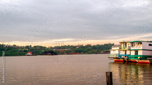the traffic at Mahakam river  Samarinda  Borneo  Indonesia. tugboat with barge of coal and wooden passenger which take passenger to the upper Mahakam
