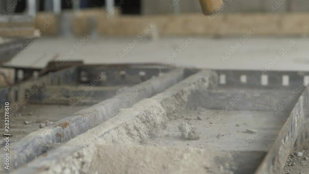 Close up of a hammer hitting concrete on a metal structure, slow motion Close up of a hammer hitting concrete on a metal structure, slow motion