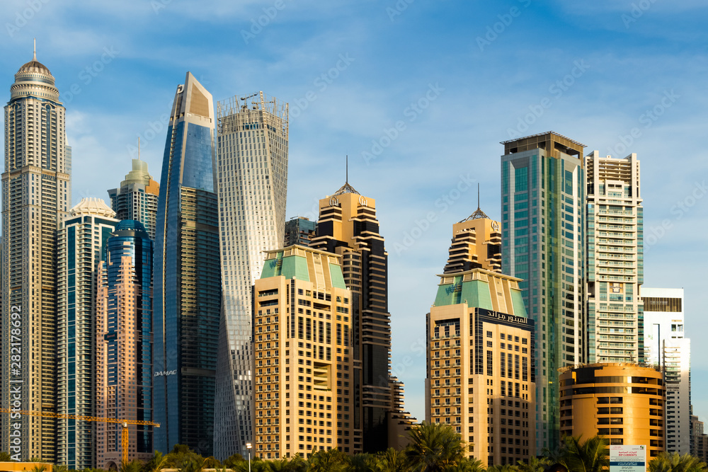 View of the high-rise buildings of Dubai from the beach. Dubai Marina district. View of the high-rise buildings of Dubai from the beach. Dubai Marina district.