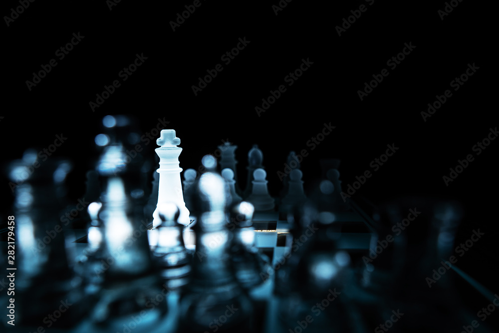 The concept of business competition: Close-up of a businessman holding a glass chess The concept of business competition: Close-up of a businessman holding a glass chess