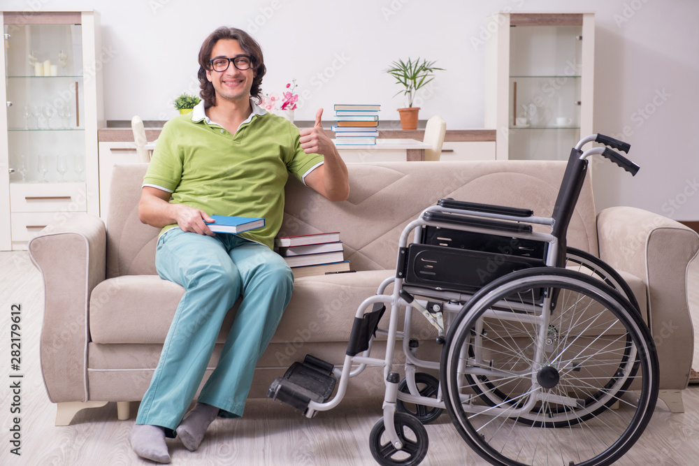 Young male student in wheelchair at home Young male student in wheelchair at home