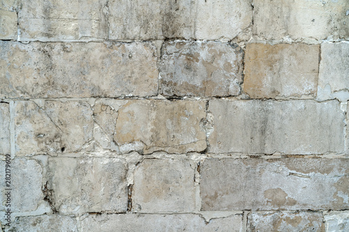 background old gray stone wall polished. repaired seams between stones. Rectangular concrete blocks. Copy space.